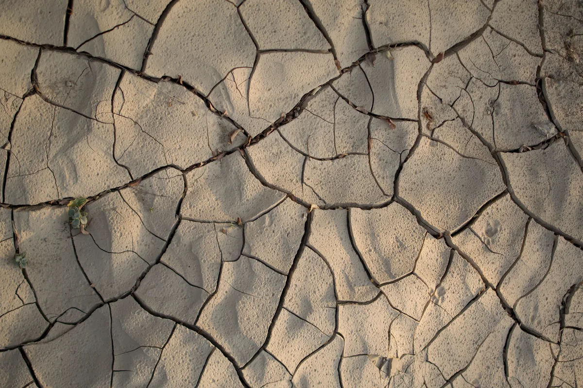 Cracked dry mud where water previously flowed in Masfout